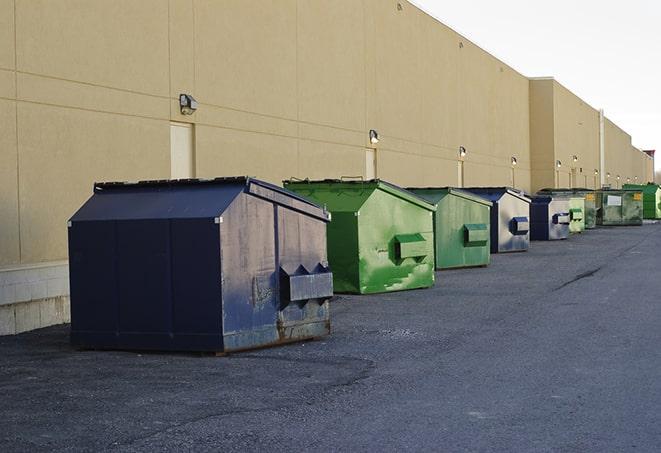 dumpsters are loaded up after the demolition of a building in Earlsboro, OK